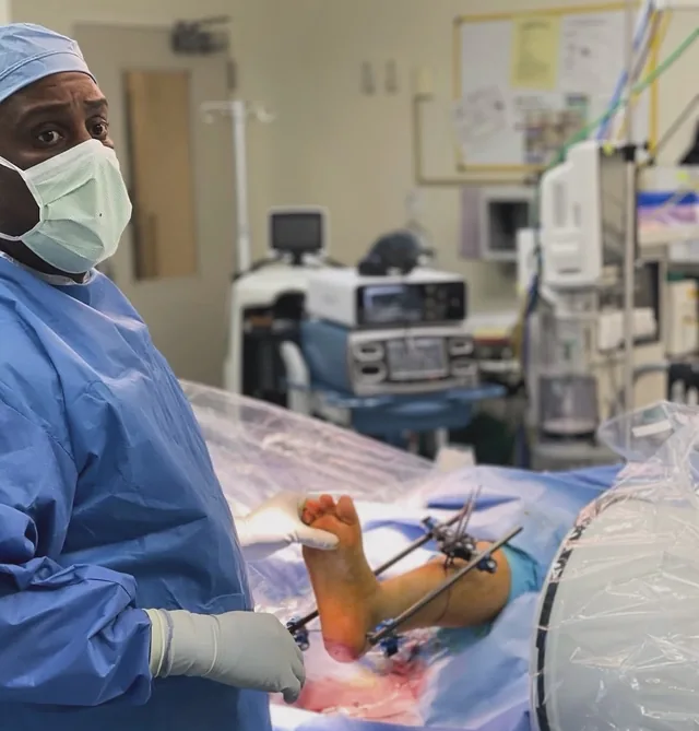Dr. Cedeno in the operating room during a foot reconstruction, an external fixation frame in place
